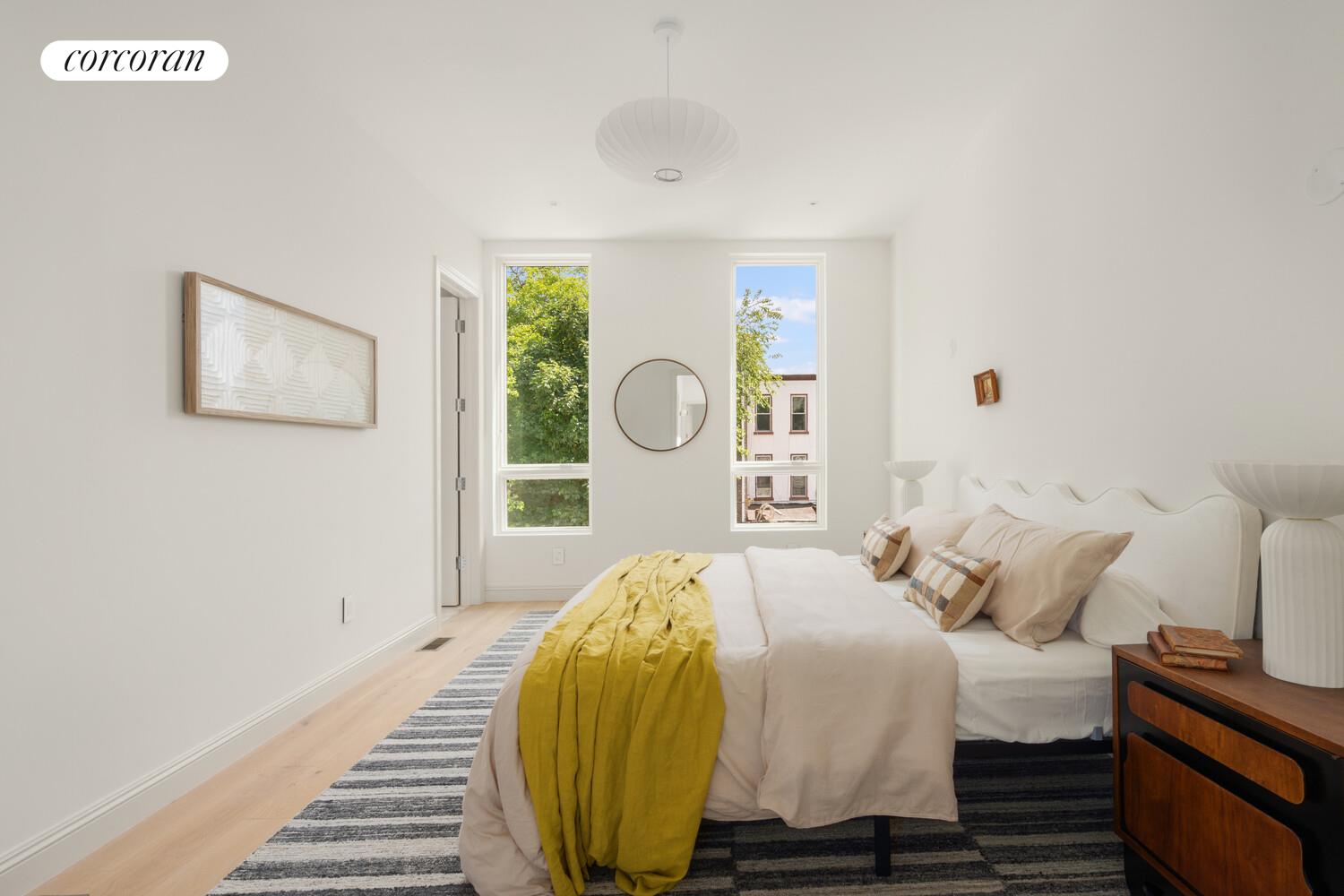 700 Monroe Street Brooklyn, NY 11221 - Photo 9 of 18 a bedroom with a bed and a lamp on dresser
