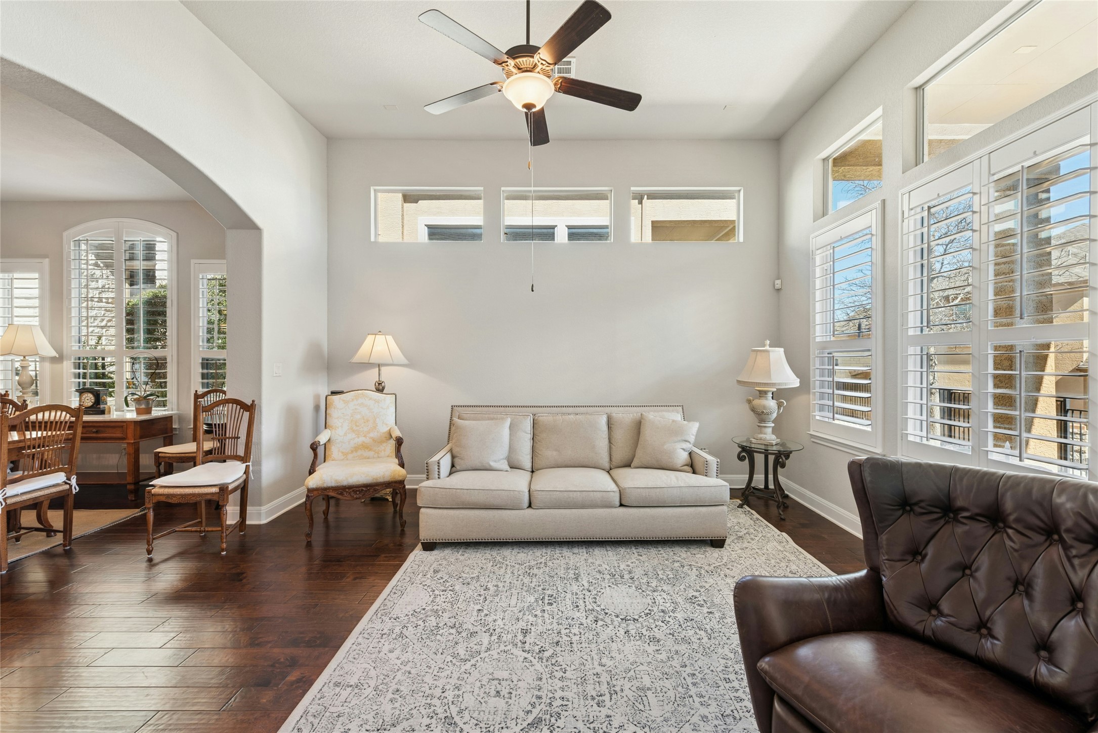 116 Evolutions Path Lakeway, TX 78738 - Photo 13 of 34 Living room featuring a ceiling fan, dark wood-type flooring, and arched walkways