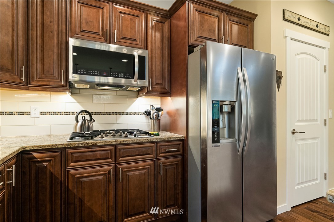 6800 Goodwin Road Everson, WA 98247 - Photo 17 of 40 a kitchen with stainless steel appliances granite countertop a refrigerator stove and microwave