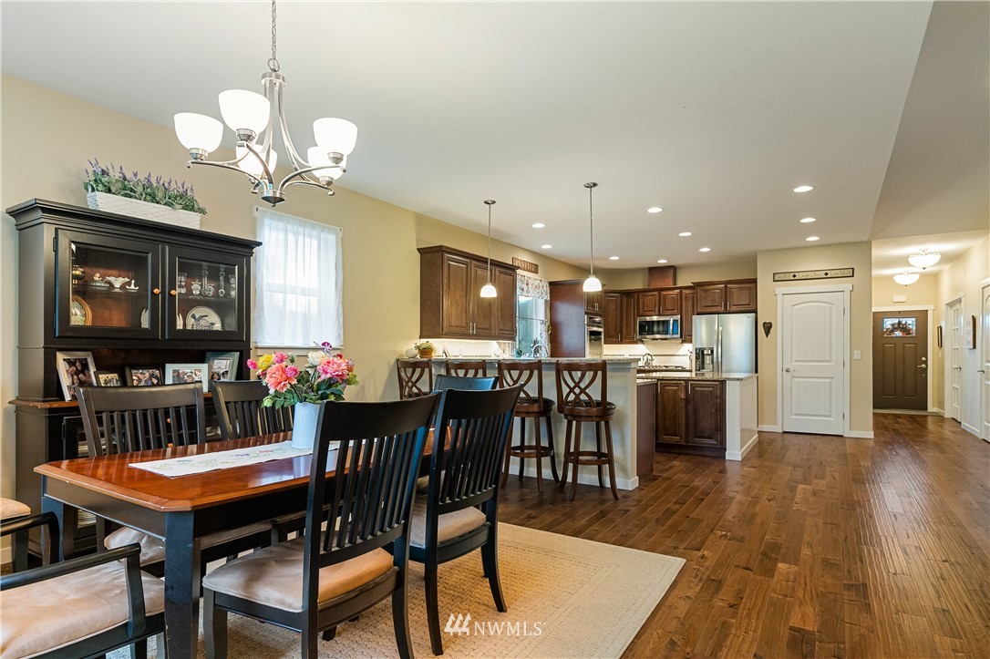 6800 Goodwin Road Everson, WA 98247 - Photo 20 of 40 a dining room filled chandelier and wooden floor