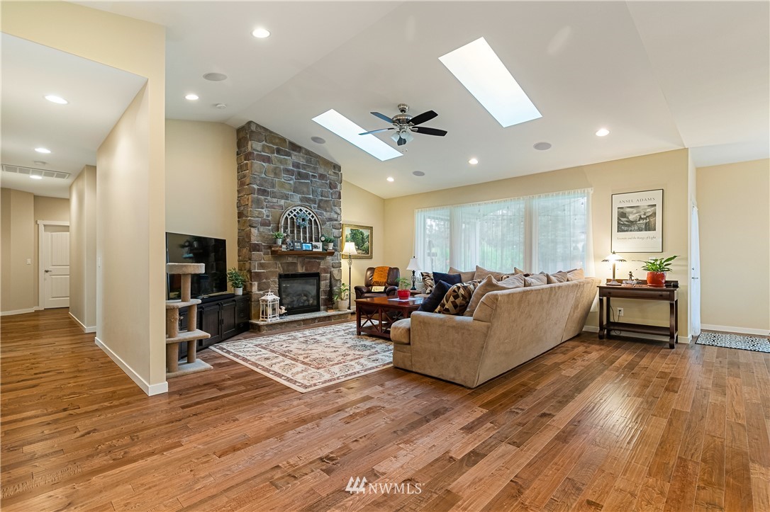 6800 Goodwin Road Everson, WA 98247 - Photo 21 of 40 a living room with furniture wooden floor and a fireplace