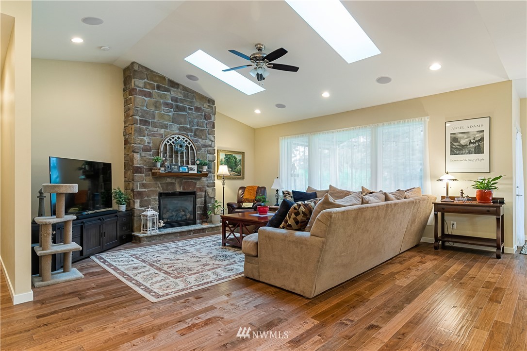 6800 Goodwin Road Everson, WA 98247 - Photo 22 of 40 a living room with furniture a fireplace and a flat screen tv