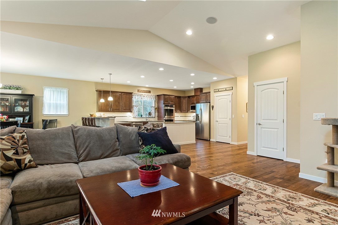 6800 Goodwin Road Everson, WA 98247 - Photo 23 of 40 a living room with furniture and a dining table with wooden floor