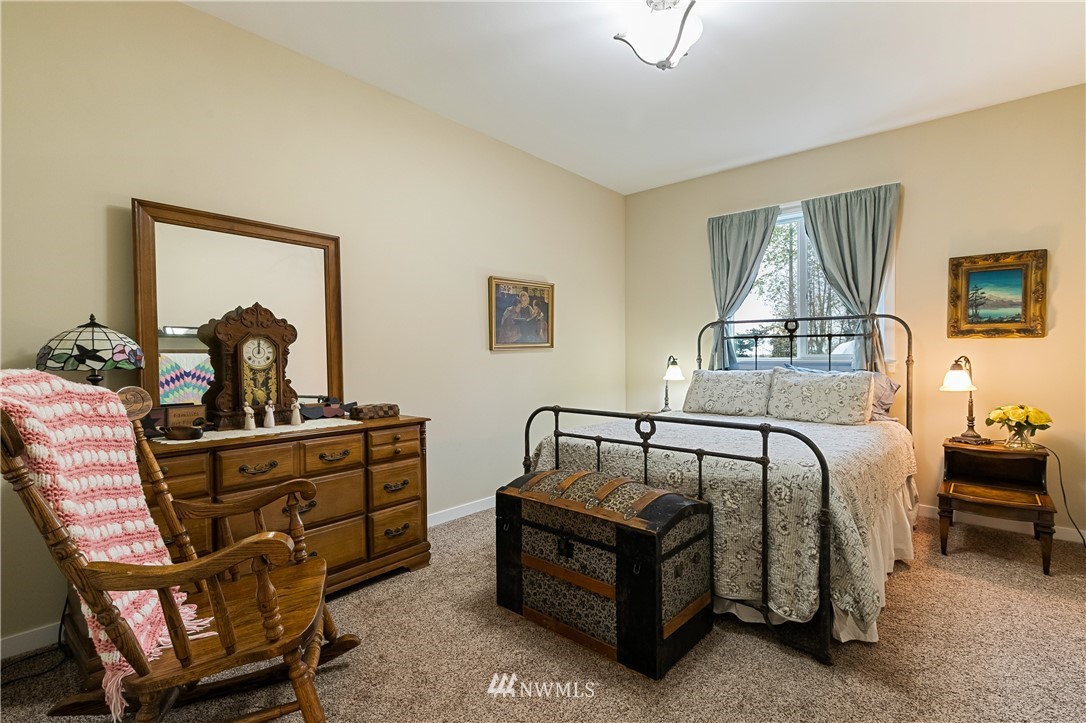 6800 Goodwin Road Everson, WA 98247 - Photo 28 of 40 a bedroom with a bed and wooden floor