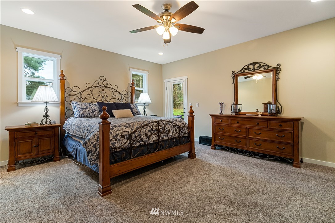 6800 Goodwin Road Everson, WA 98247 - Photo 32 of 40 a bedroom with a bed and a chandelier