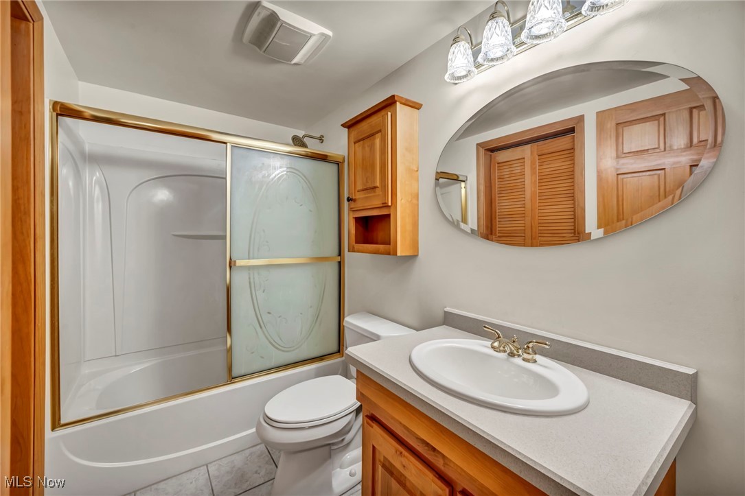 1263 Lost Nation Road, Unit 5 Willoughby, OH 44094 - Photo 22 of 26 Full bath featuring vanity, bath / shower combo with glass door, and light tile patterned floors