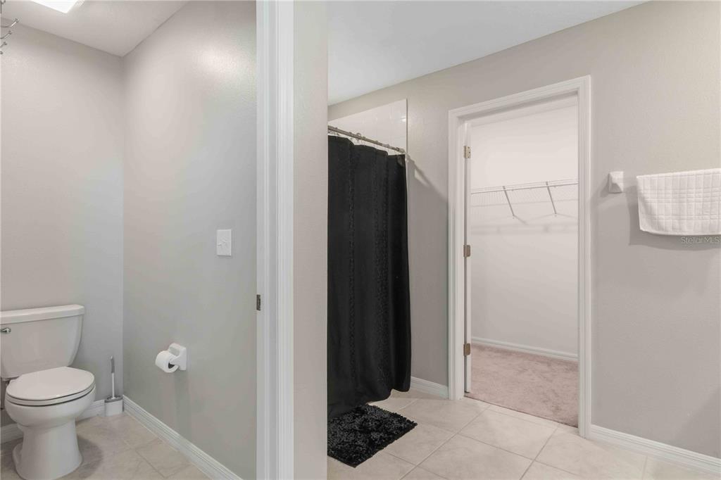 9440 Lemon Drop Loop Sun City Center, FL 33573 - Photo 34 of 55 a bathroom with a toilet and a shower