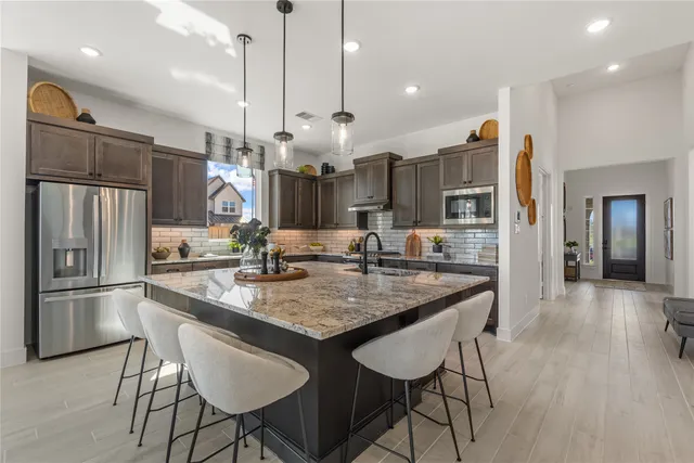 a kitchen with stainless steel appliances wooden cabinets and stove