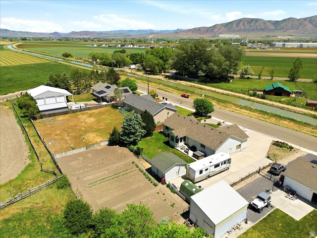 72 Canal Bank Road Garland, UT 84312 - Photo 36 of 40 Expansive property featuring a cultivated garden plot, a large fenced yard, and multiple outbuildings