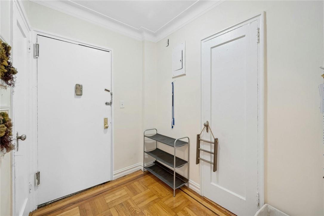 2025 Valentine Avenue, Unit 6B Bronx, NY 10457 - Photo 12 of 15 Foyer entrance with light parquet floors and crown molding
