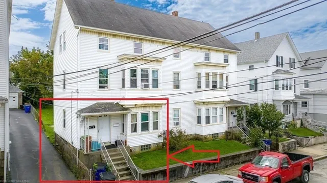 a view of a building with many windows and yard