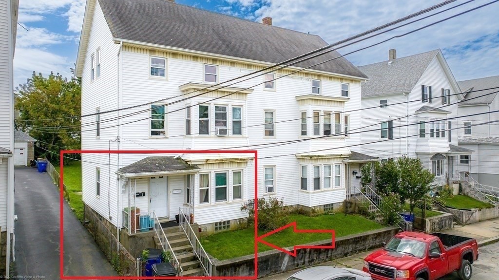 623-631 Birch Street, Unit 1 Fall River, MA 02724 - Photo 1 of 17 a view of a building with many windows and yard