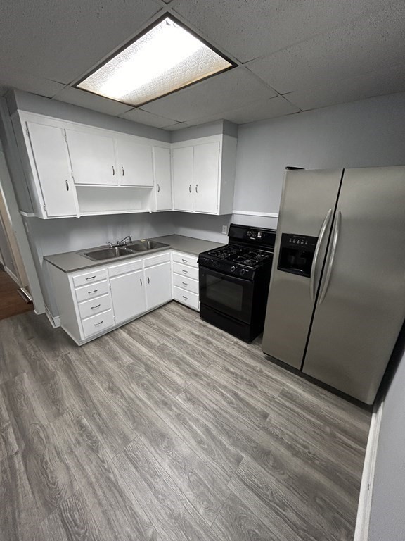 623-631 Birch Street, Unit 1 Fall River, MA 02724 - Photo 4 of 17 a kitchen with granite countertop a refrigerator stove and sink