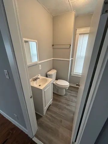 a white toilet sitting next to a bathroom sink