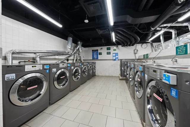 a utility room with dryer washer and other items