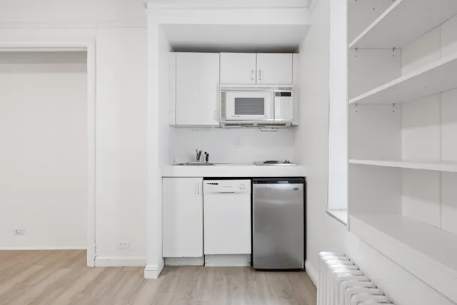 a kitchen with stainless steel appliances granite countertop a refrigerator and a microwave