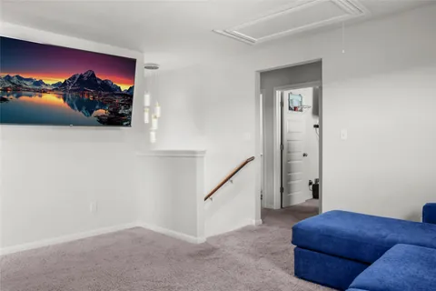 a view of a livingroom with furniture and stairs