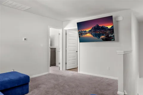 a view of a room with a painting on the wall