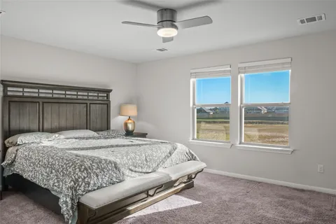 a bedroom with a bed dresser and a window