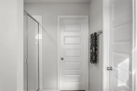a bathroom with a glass shower door