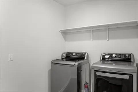 a view of storage and utility room with washer and dryer