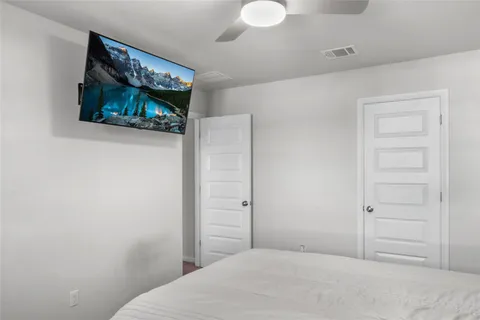 a bedroom with a bed and a television