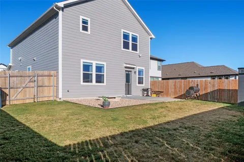 a view of a house with a yard and sitting area