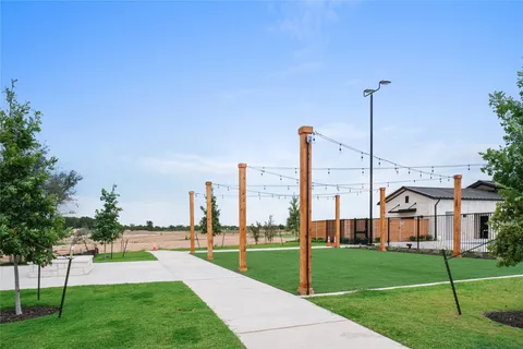 a view of a city with tall buildings and a big yard