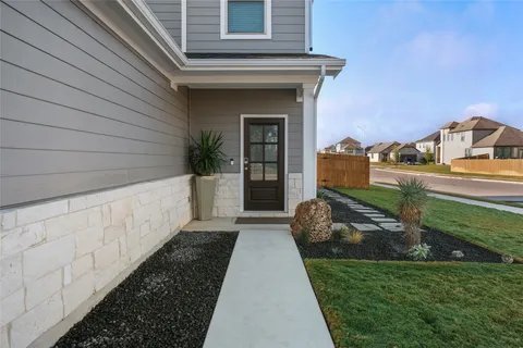 a front view of a house with a garden