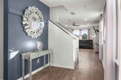 a view of entryway and hall with wooden floor