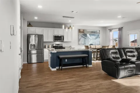 a kitchen with stainless steel appliances a stove a refrigerator and a refrigerator
