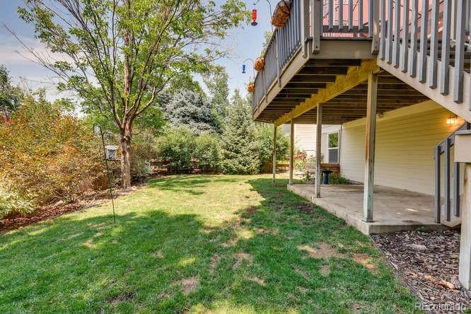 1672 Spring Water Place Highlands Ranch, CO 80129 - Photo 24 of 25 a view of a backyard with wooden fence