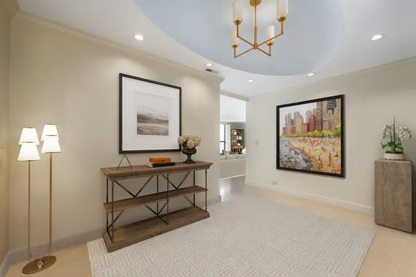 a living room with furniture a window and a painting on the wall