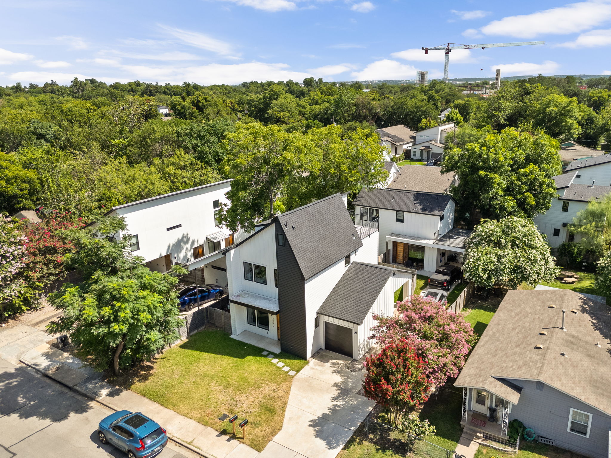2717 Lyons Road, Unit 1 Austin, TX 78702 - Photo 38 of 40 An aerial perspective reveals a contemporary home with clean lines nestled amongst mature trees and lush surroundings.