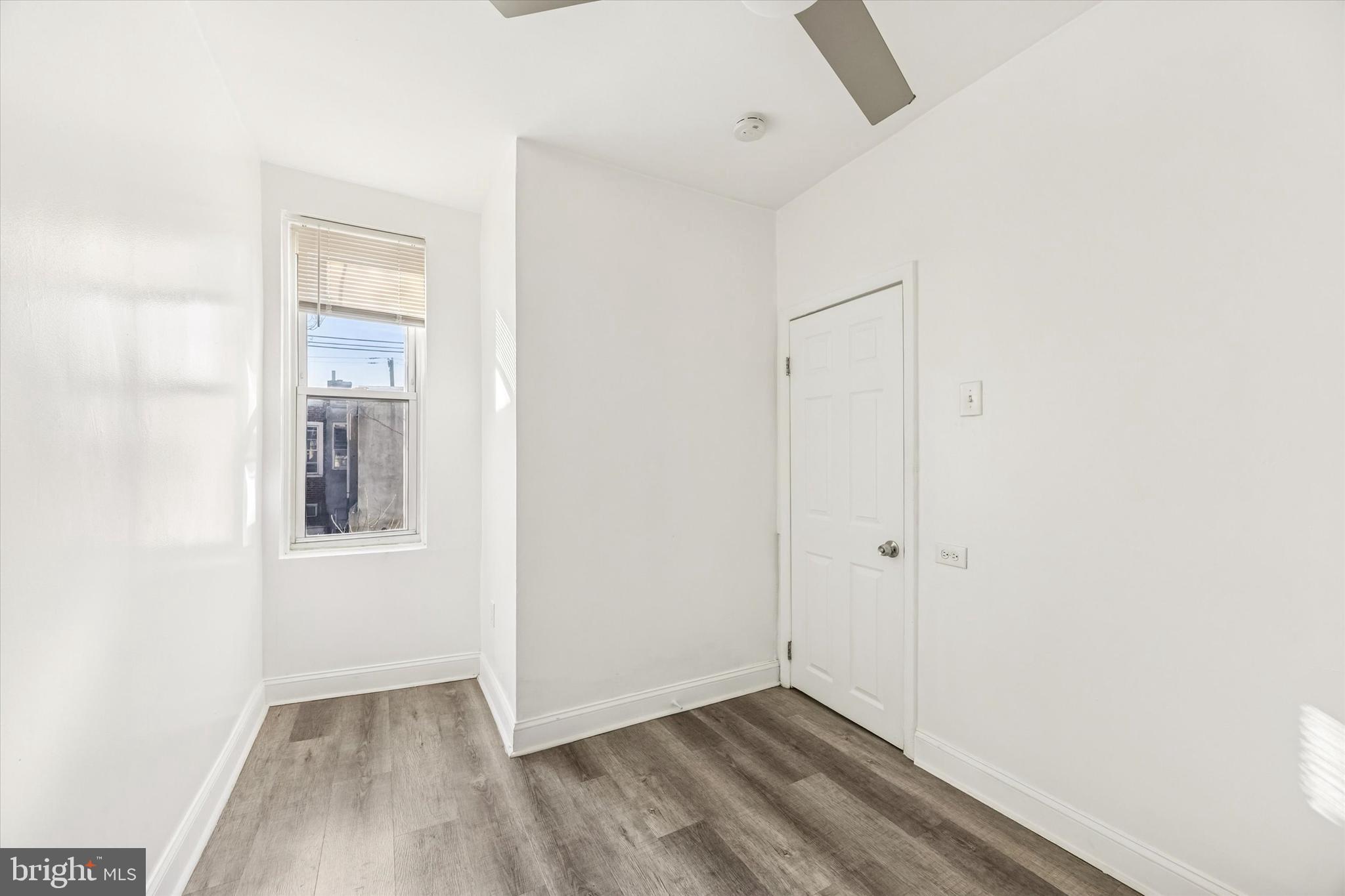 2336 Pierce Street Philadelphia, PA 19145 - Photo 14 of 18 an empty room with wooden floor and windows