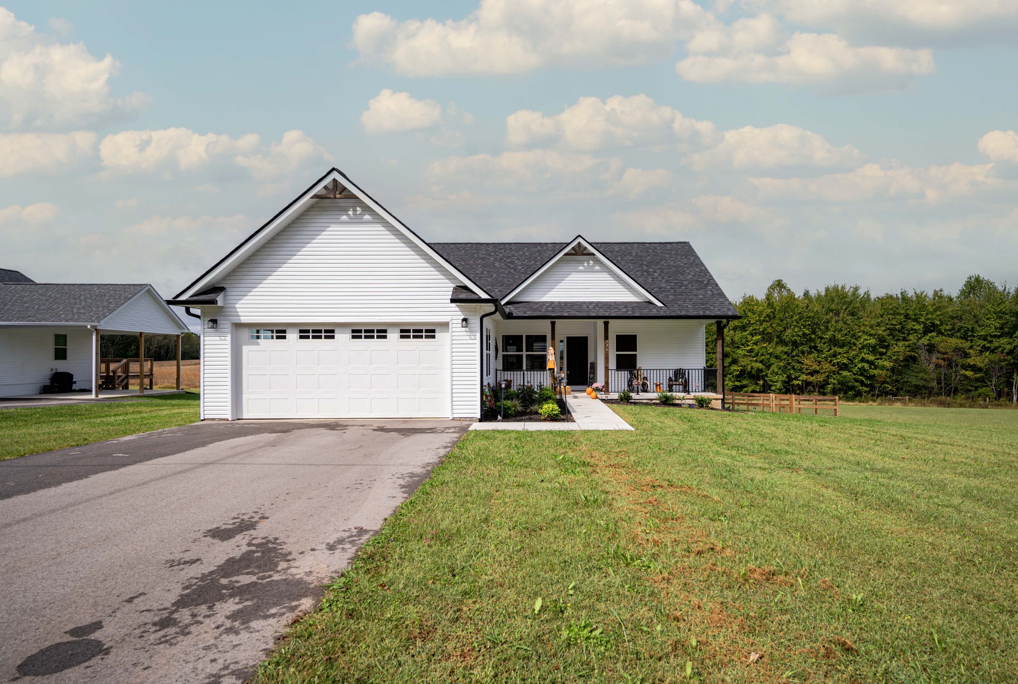 a front view of a house with garden and porch