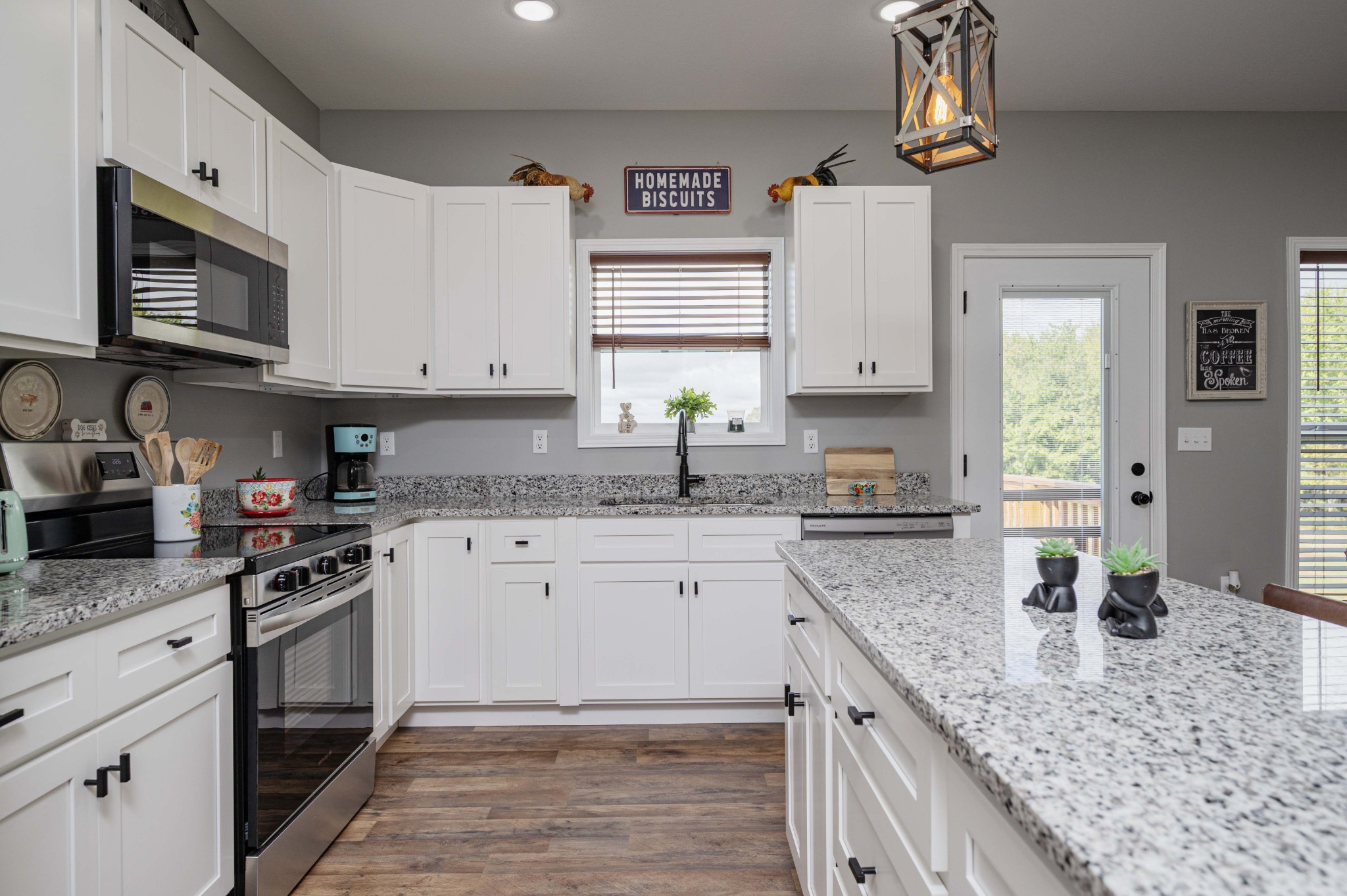 536 Frank Anderson Road Sparta, TN 38583 - Photo 11 of 25 a kitchen with granite countertop a sink stainless steel appliances and white cabinets