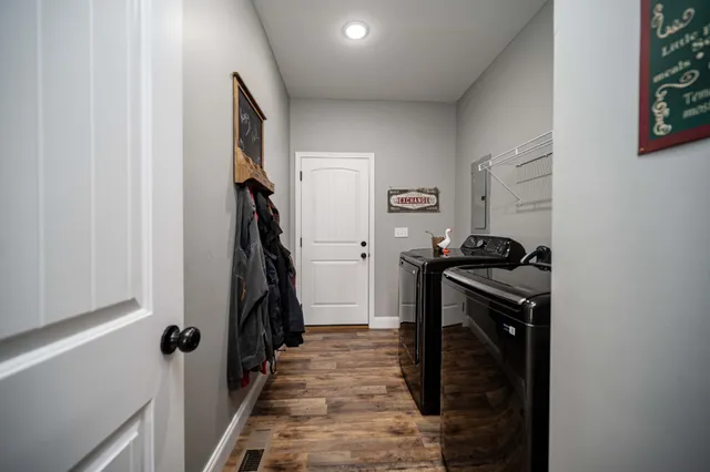 a view of a livingroom with wooden floor and staircase