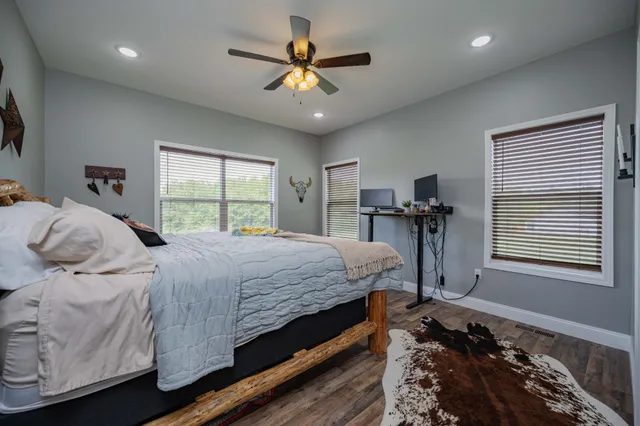 a bedroom with bed and a chandelier