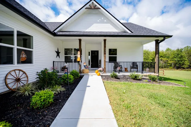 a view of a house with backyard and sitting area