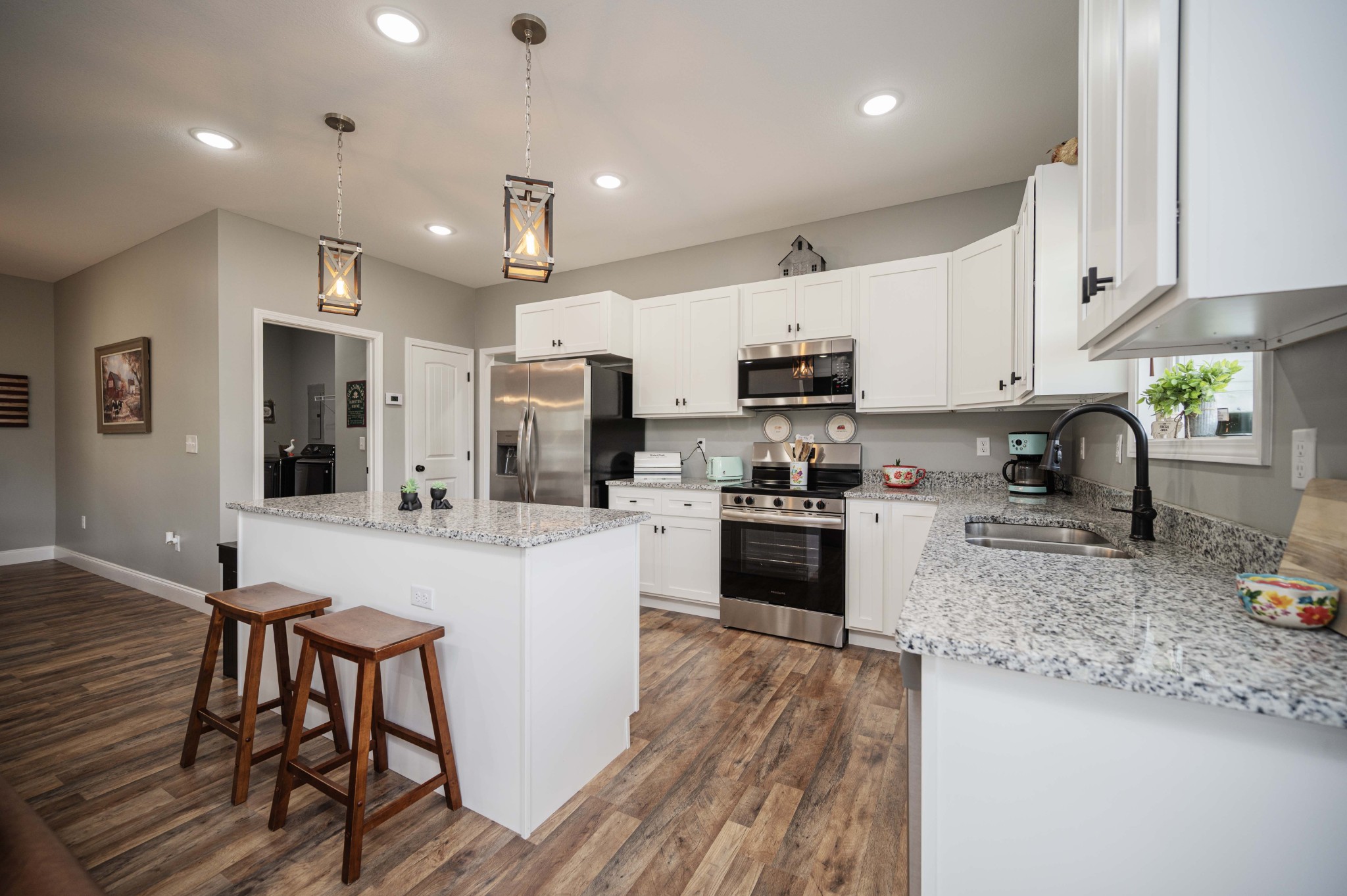 536 Frank Anderson Road Sparta, TN 38583 - Photo 10 of 25 a kitchen with stainless steel appliances granite countertop a refrigerator oven a sink a stove a dining table and chairs with wooden floor