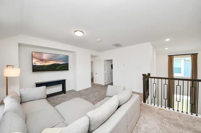 a view of a hallway with a livingroom and entryway