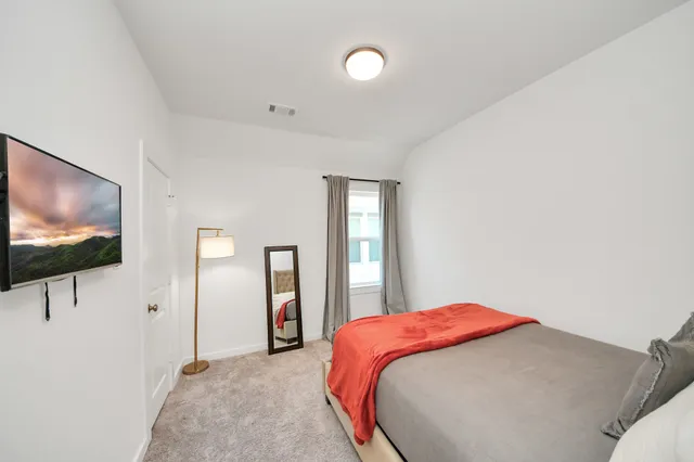 a bedroom with a bed and a couch