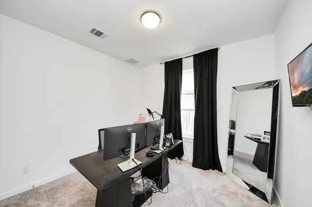 a laptop sitting on top of a wooden floor