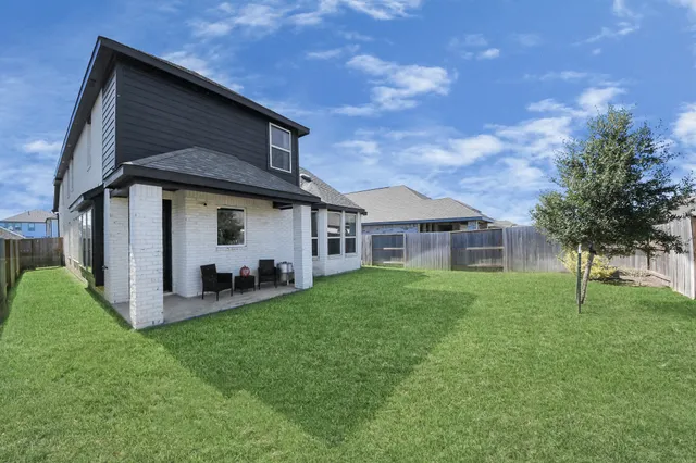 a view of a house with a backyard