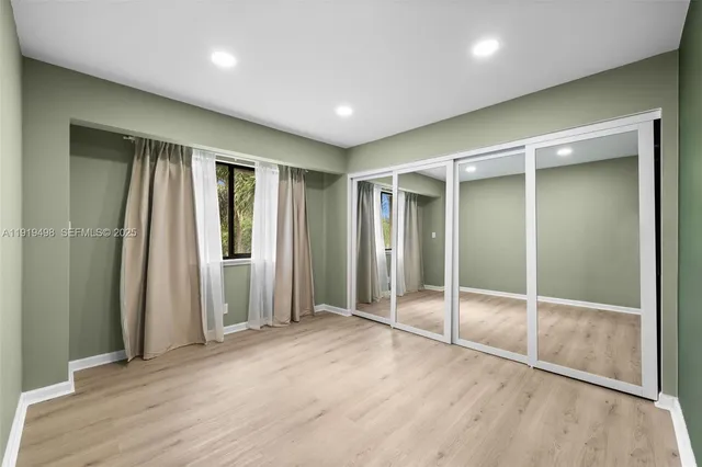 an empty room with wooden floor