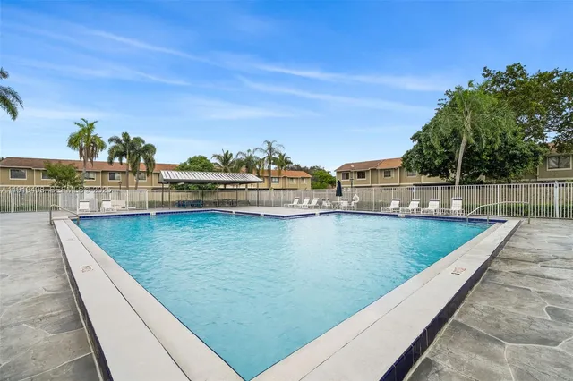 an aerial view of residential houses with outdoor space and street view