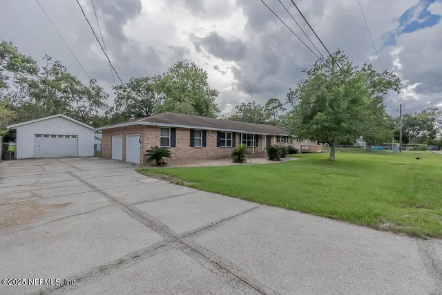 a front view of house with yard and green space