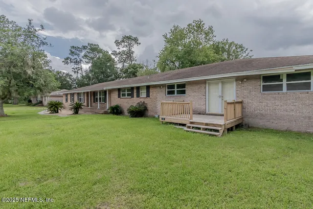 a view of a house with backyard sitting area and garden