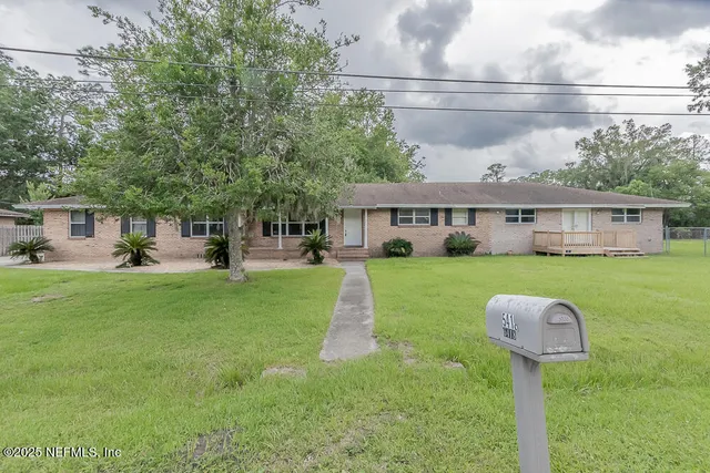 a front view of house with yard and green space